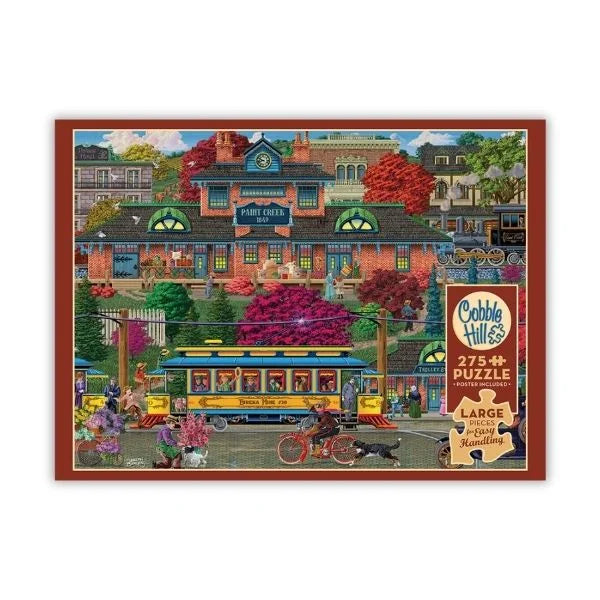 Cobble Hill puzzle box with a colorful illustration of a town scene 